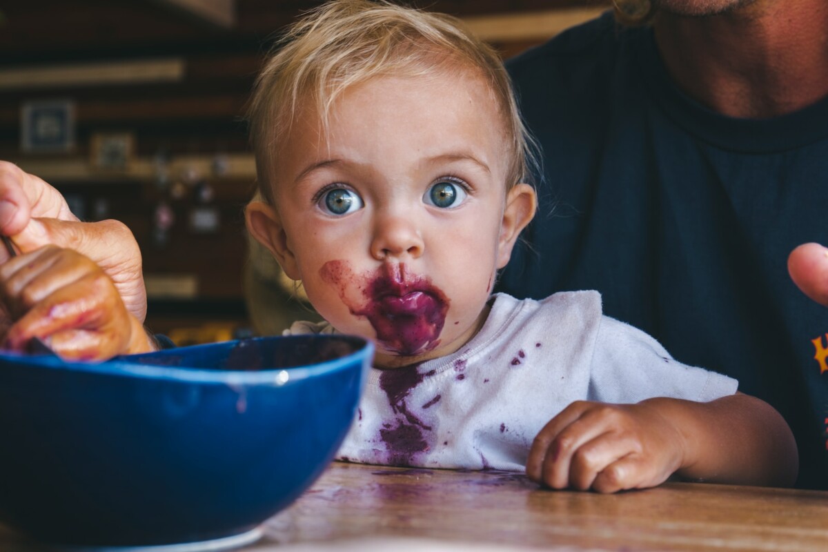a little girl with food all over her face